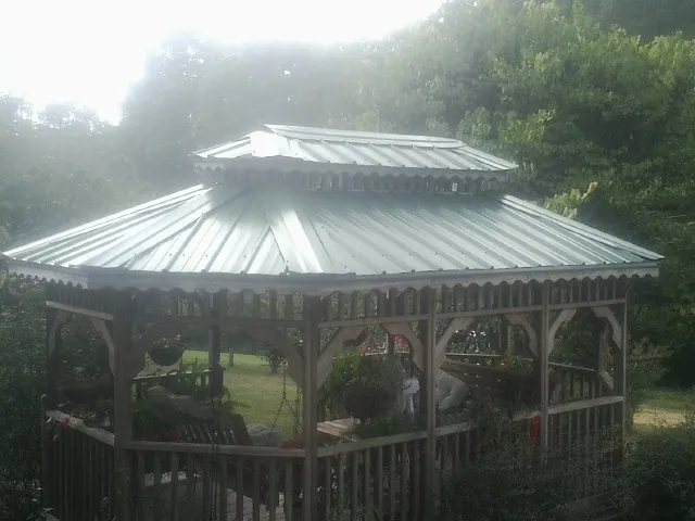 Two tier green metal roof on a garden gazebo in Waimanalo