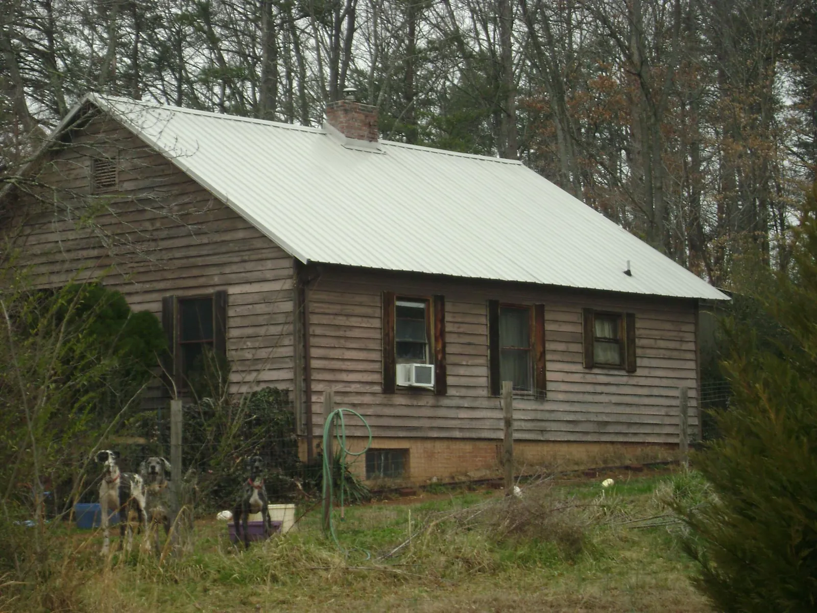 White metal roof on an old wood sided farmhouse, from a Asphalt Shingle Roof Repair job in Waimanalo